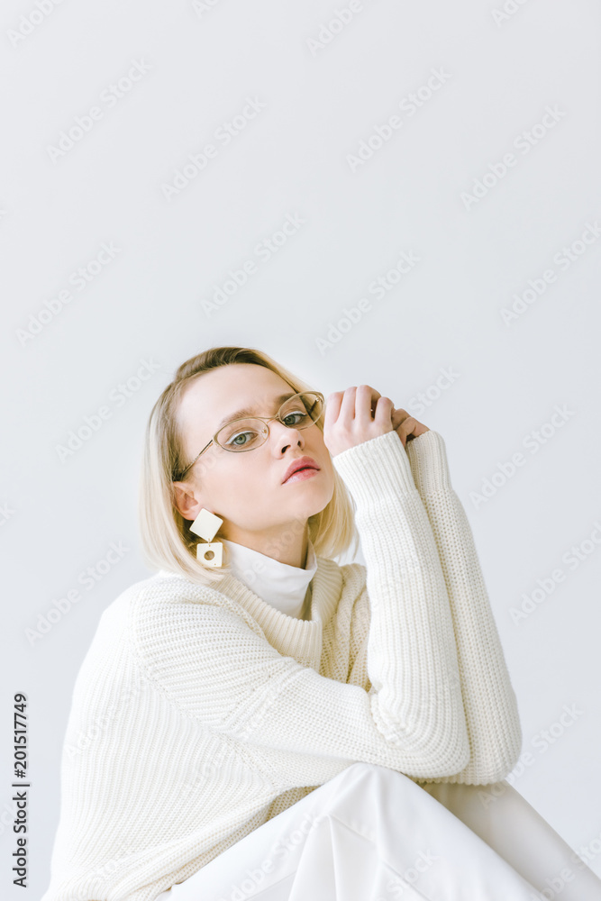 beautiful stylish blonde woman in white clothes sitting isolated on white beautiful stylish blonde woman in white clothes sitting isolated on white