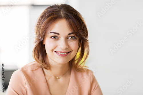 people, emotion and facial expression concept - portrait of happy smiling young woman