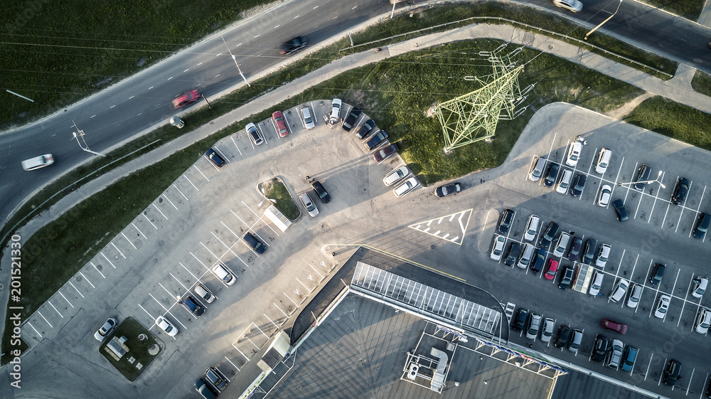 Aerial view from drone on car parking next to the supermarket.