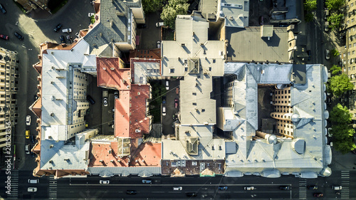 Aerial view from drone on city landscape of Riga, Latvia. Sunny day. Rooftops and houses with yards on image.