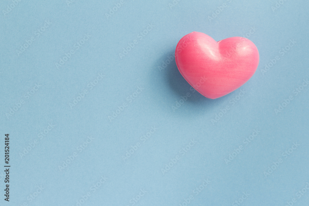 Red heart shape over blue table. Romantic Valentine Day concept with copy space Red heart shape over blue table. Romantic Valentine Day concept with copy space