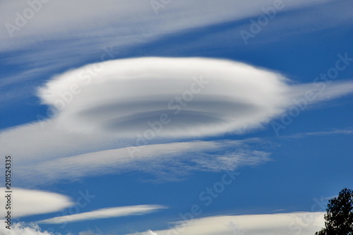 Lenticular clouds over the mountains at Queenstown, New Zealand photo