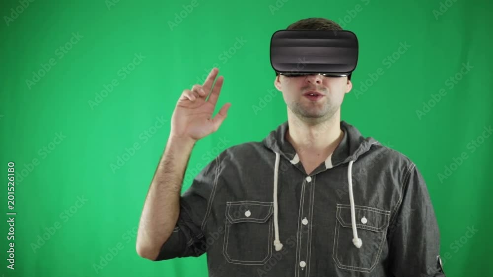 A man in virtual reality glasses makes gestures in the air. A man in virtual reality glasses makes gestures in the air.