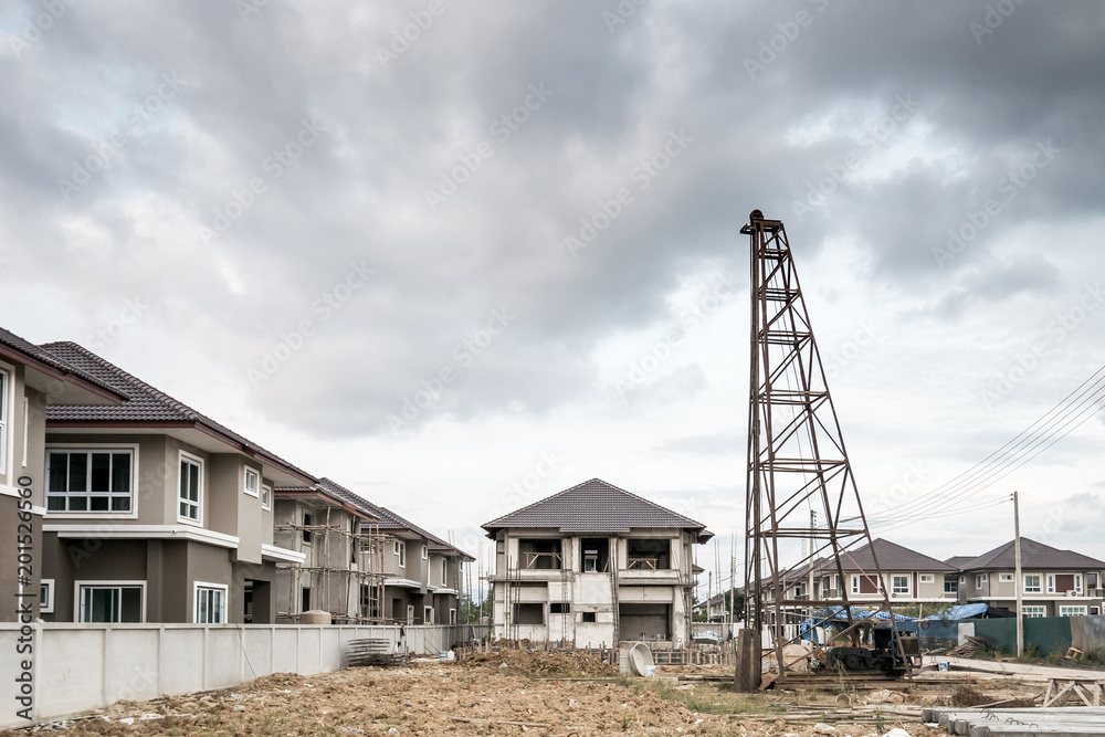 Residential new house building at construction site with clouds and blue sky Residential new house building at construction site with clouds and blue sky