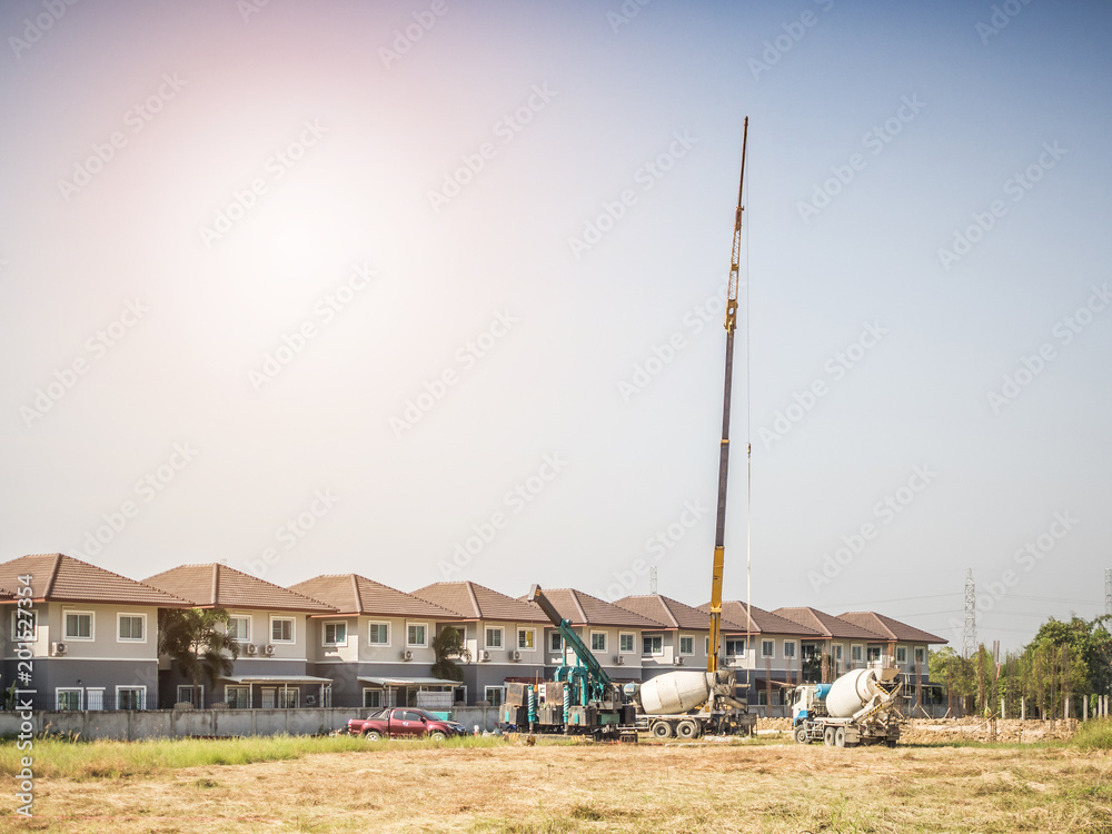 House building at construction site with crane truck