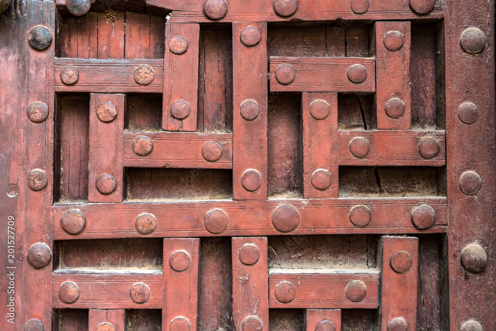 Old wooden door with decorative pattern in India Old wooden door with decorative pattern in India