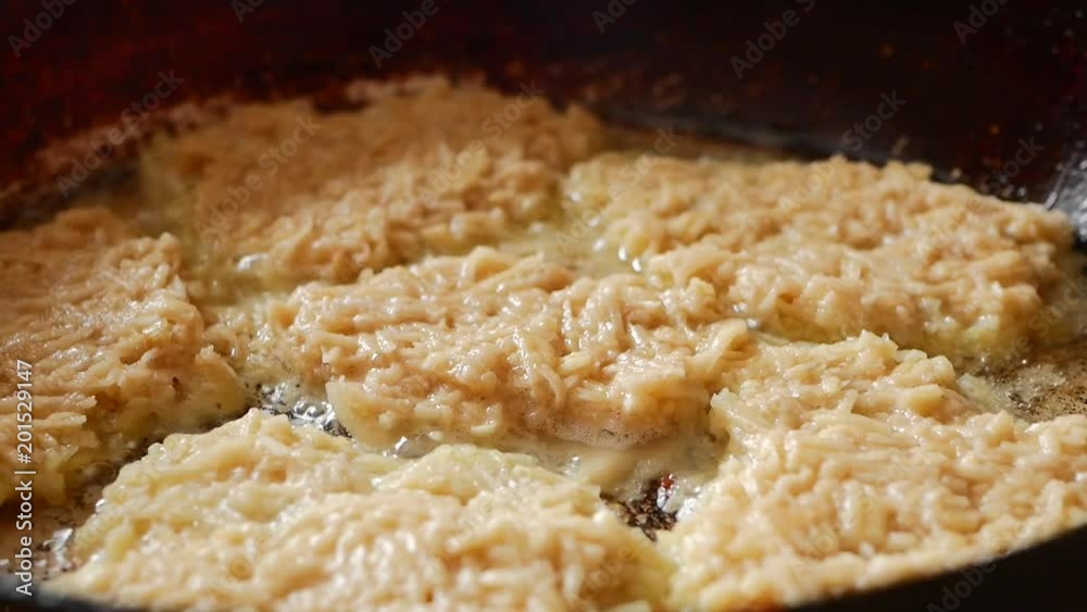 cook of golden crispy potato pancakes in a frying pan