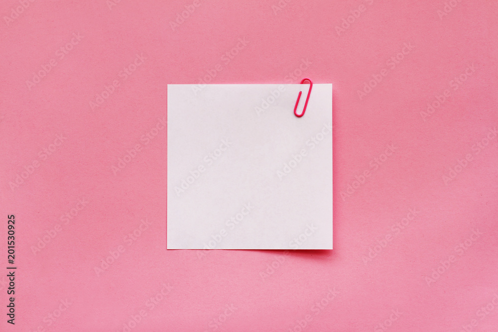 White note paper label with clip on pink background White note paper label with clip on pink background