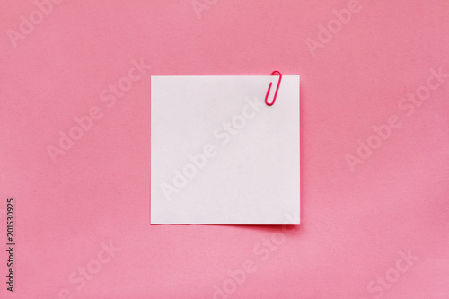 White note paper label with clip on pink background