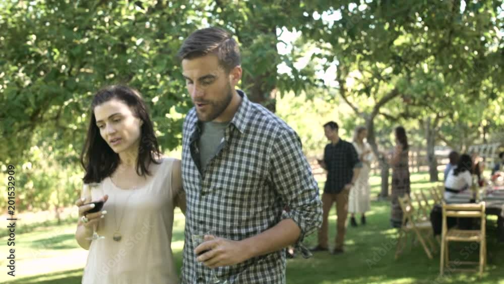Young couple walking away from a group Young couple walking away from a group