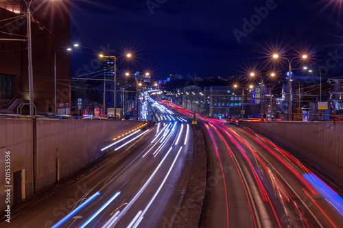 Выезд из тоннеля. Автодорога в городе вечером, фонари, размытые следы автомобильных фар. Москва, Россия