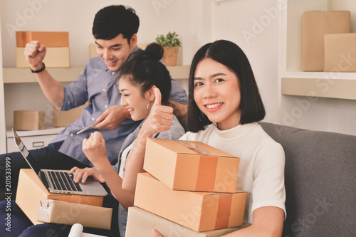 Sme business concept. Young Asian people are packing their packages.Delivery business  Small and Medium Enterprise (SMEs). Young man is working in the house.Young Owner Start up for Business Online. © S photographer