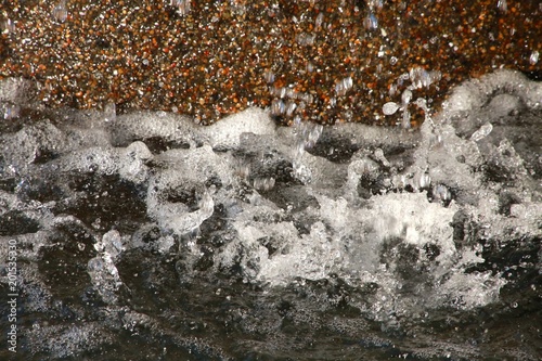 Base of Brown Stone Fountain with Water Splattering in Closeup