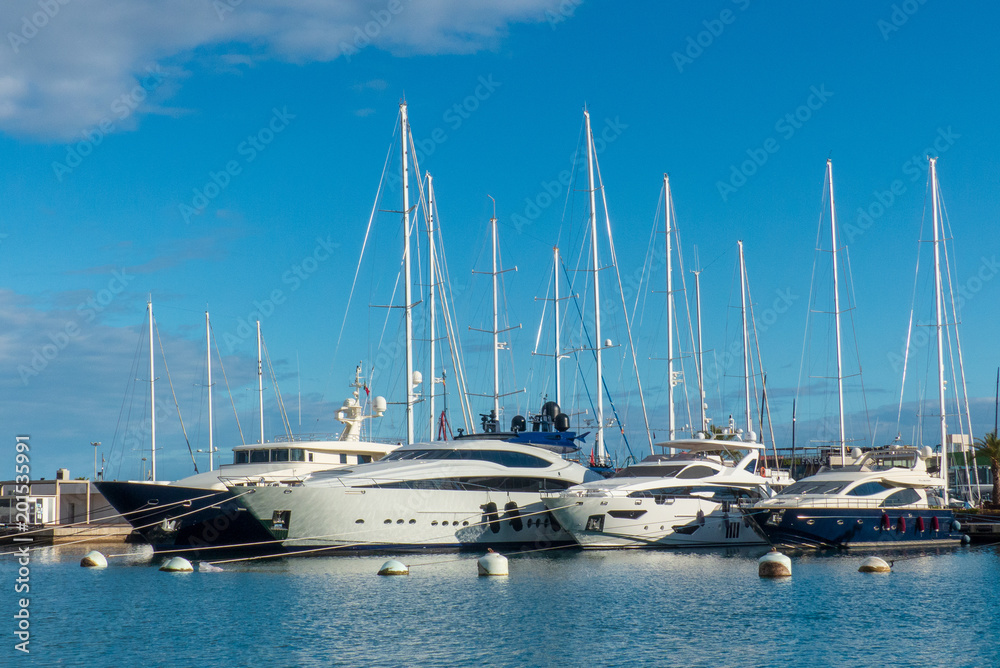 Spectacular view of the luxury yachts in the port of valencia with the blue sky and clouds at sunset in spring Spain