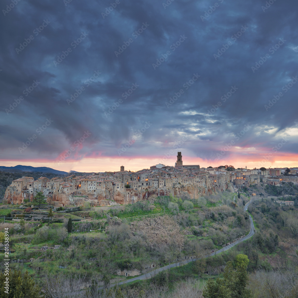 dramatic sky above old city in Tuscany in Italy in spring morning