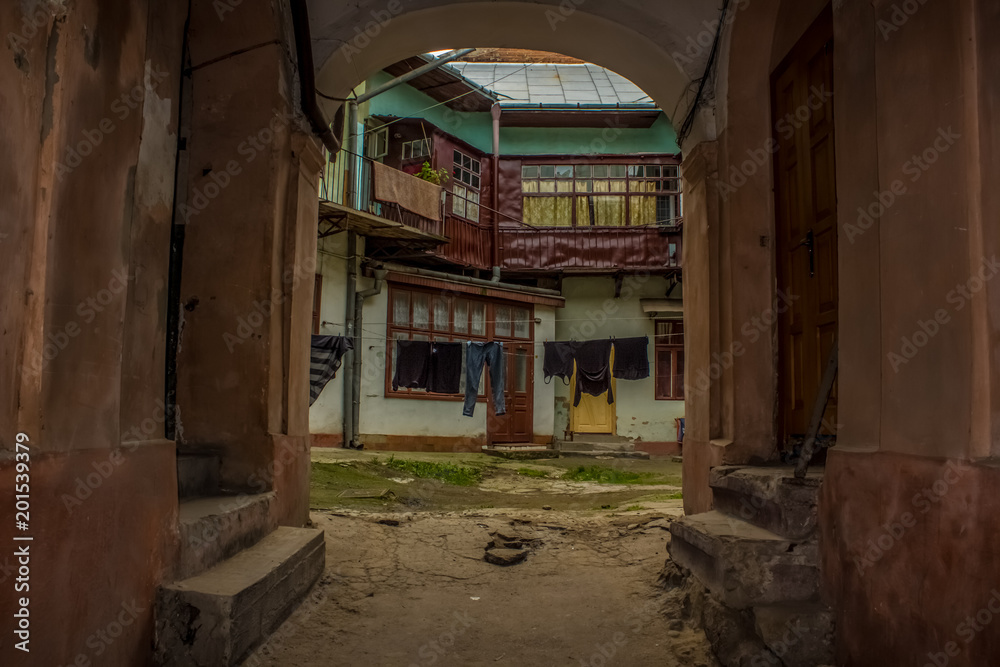 Backstreet empty yard with dry clothes in poor city district Backstreet empty yard with dry clothes in poor city district