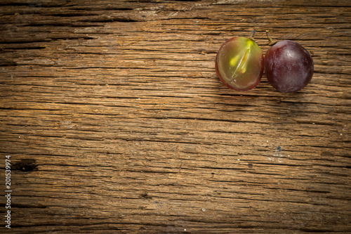 red grapes. slice. half. on wooden table