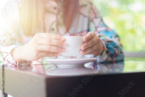 Woman drinking coffee at coffee shop