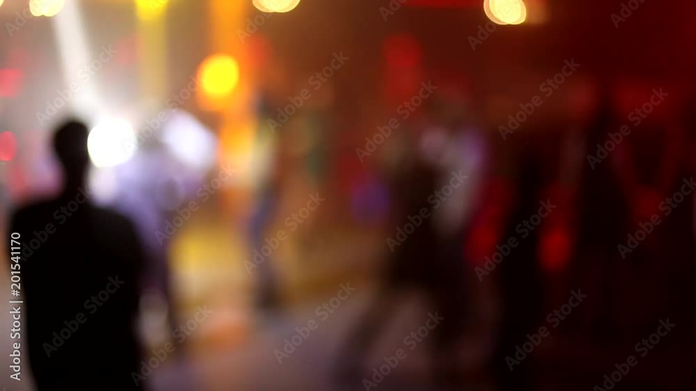 People dance have fun and relax in the nightclub blurred background. Flashes of light, beautiful blurred lights on the dance floor, a lot of people relax at night in the club. No focus video People dance have fun and relax in the nightclub blurred background. Flashes of light, beautiful blurred lights on the dance floor, a lot of people relax at night in the club. No focus video