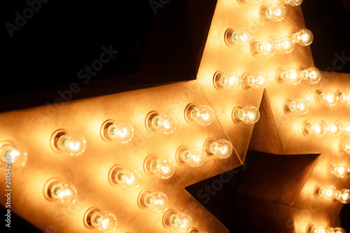 Decorative star with lamps on a background of wall. Modern grung