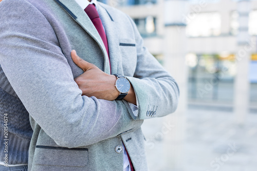 Closeup of a business mans watch and suit