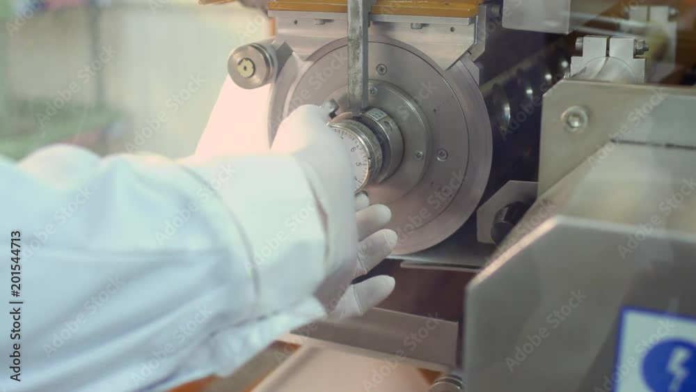 Worker in rubber glove adjust valve inside the machine Worker in rubber glove adjust valve inside the machine