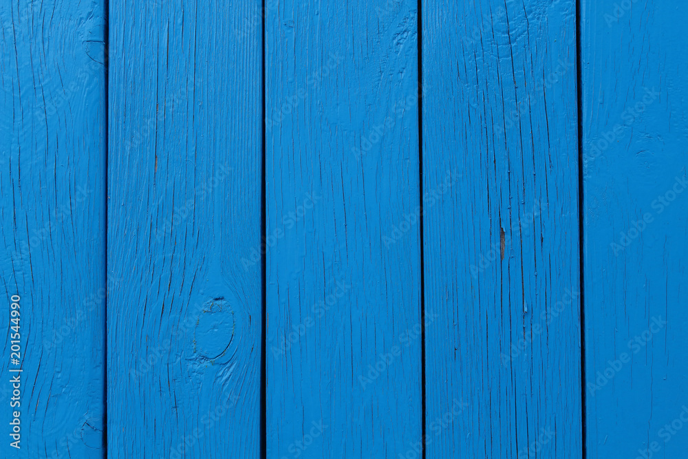 Obraz premium The wall of the house is made of blue boards. Close-up. Background. Texture.