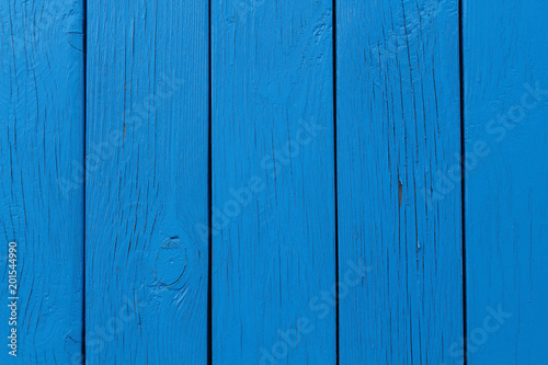 The wall of the house is made of blue boards. Close-up. Background. Texture.
