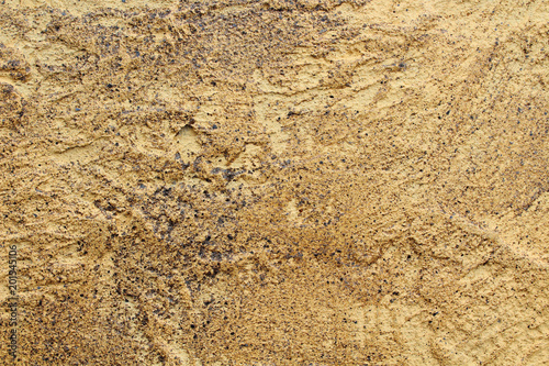 Wall of golden color of concrete. decorative interior. Close-up. Background. Texture.