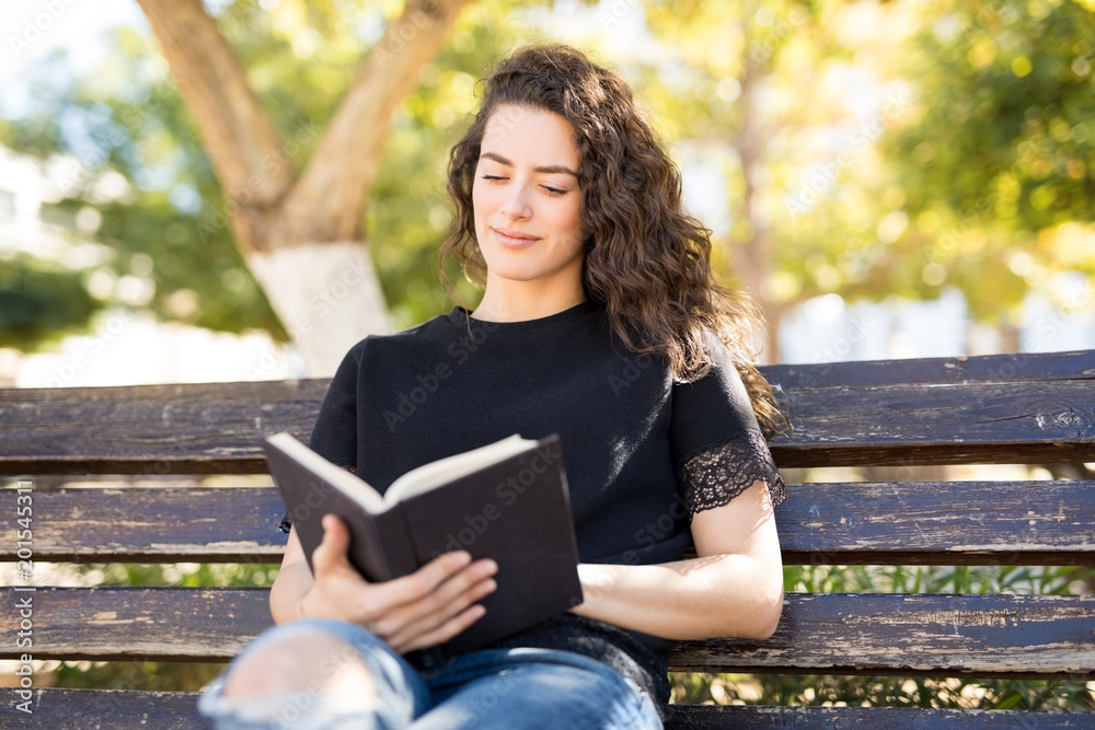 Beautiful woman reading book in park Beautiful woman reading book in park
