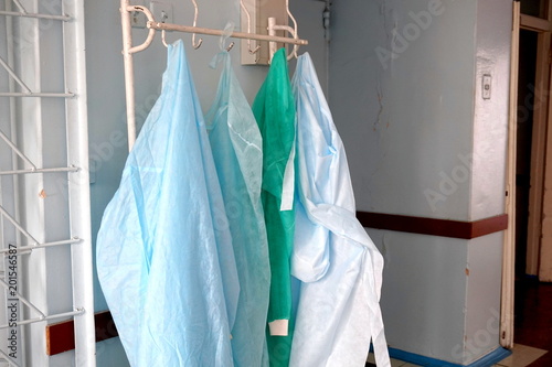 A medical robe hangs on a hanger at the entrance to the hospital