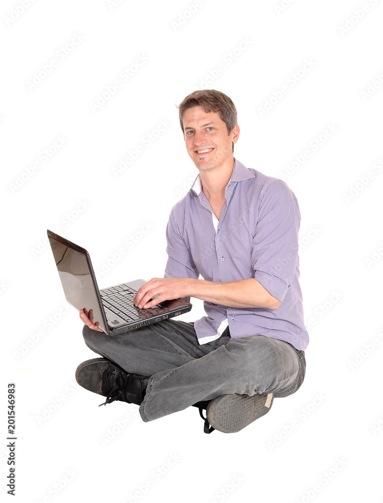 Man working on laptop on the floor Man working on laptop on the floor