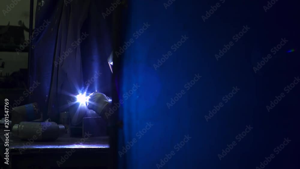 One person welding a pipe in a factory One person welding a pipe in a factory