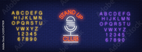 Neon alphabet and Stand up Club lettering with microphone on brick background. Show, nightclub, comedy club. Advertisement concept. For signboards, template design, banners