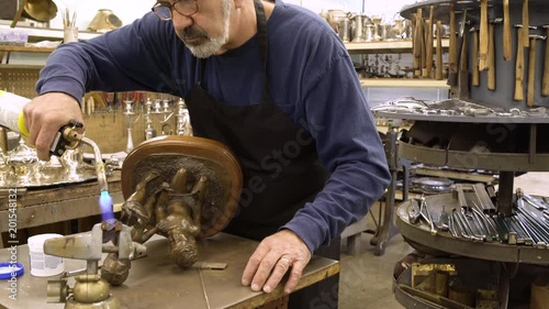 Silversmith working on a sculpture photo