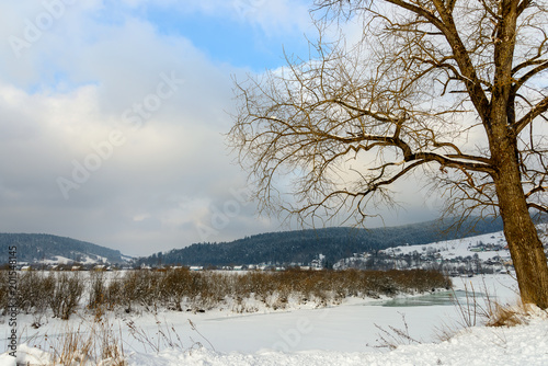 Wallpaper Mural Winter landscape. Snow-covered mountain river at the foot of the high  Mountains. Torontodigital.ca