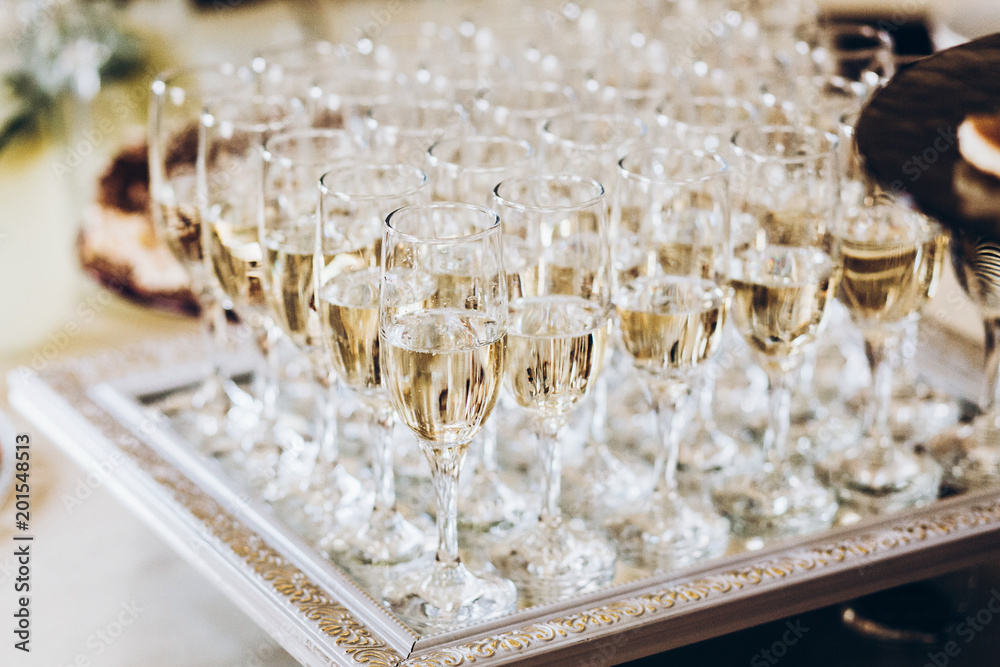 stylish glasses of champagne at luxury wedding reception. rich celebration. expensive catering at feast. new year and christmas celebrations and drinks