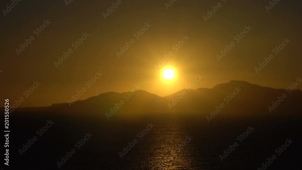 Rising Sun over the sea and desert mountains Rising Sun over the sea and desert mountains