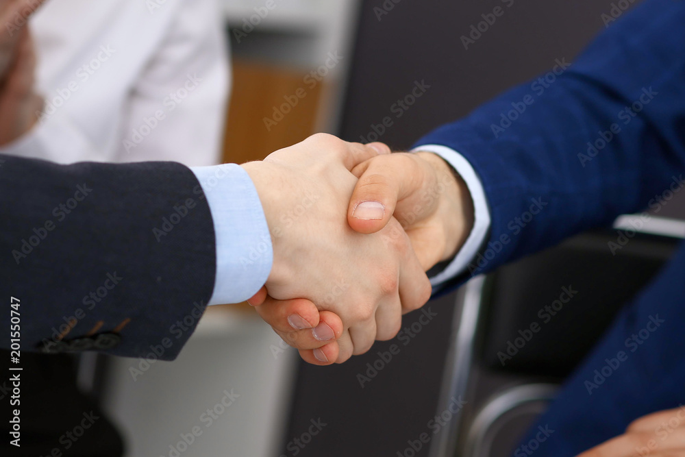 Business people shaking hands, finishing up a meeting. Audit, tax service or agreement concept