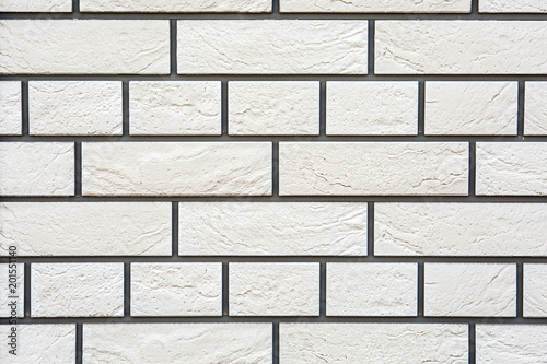 Tiles of house facade, white brick wall background.