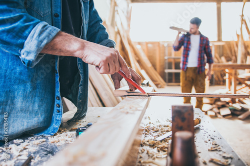 Carpenters at work, constructing and working with wood photo