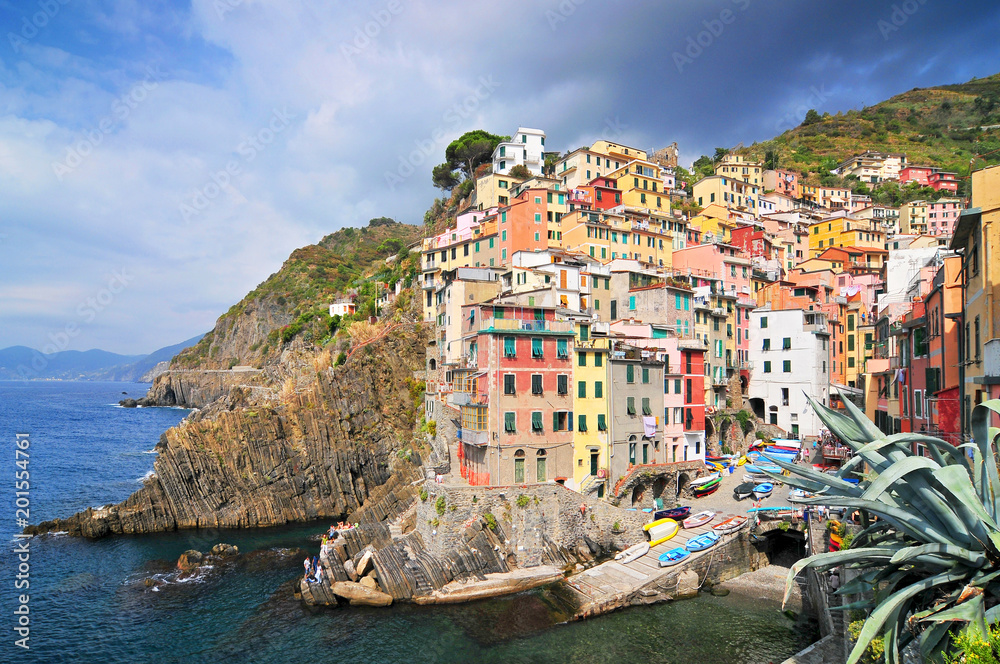 The colorful houses of the fishing port of Riomaggiore, Cinque Terre National Park, Liguria, Italy.