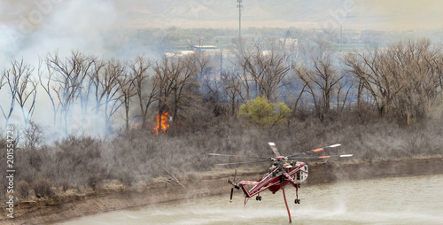Heavy firefighting helicopter drafts water from the Colorado River