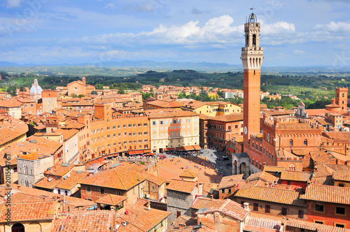 City view of Siena, Tuscany, Italy, with bell tower and square: Torre del Mangia and Piazza del Campo.