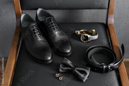Set of male clothes and accessories. The groom is gathering in the morning. Kit on black chair. Business style