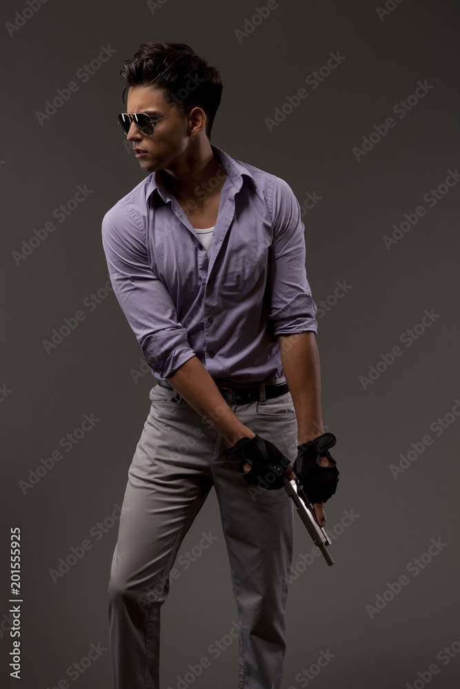 Fototapeta premium stylish shooter with handgun