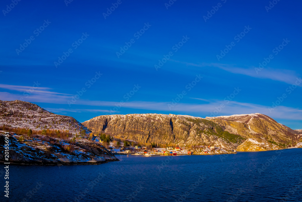 Outdoor winter views of wooden houses a long in the coast from Hurtigruten voyage, Northern Norway