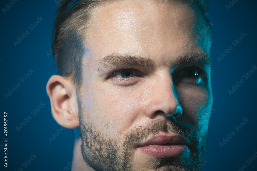 Obraz premium Man portrait. Closeup attractive unshaven man. Cropped portrait charming man with light smile. Fashion male model. Confident, successful, satisfied businessman. People, lifestyle and emotion concept.