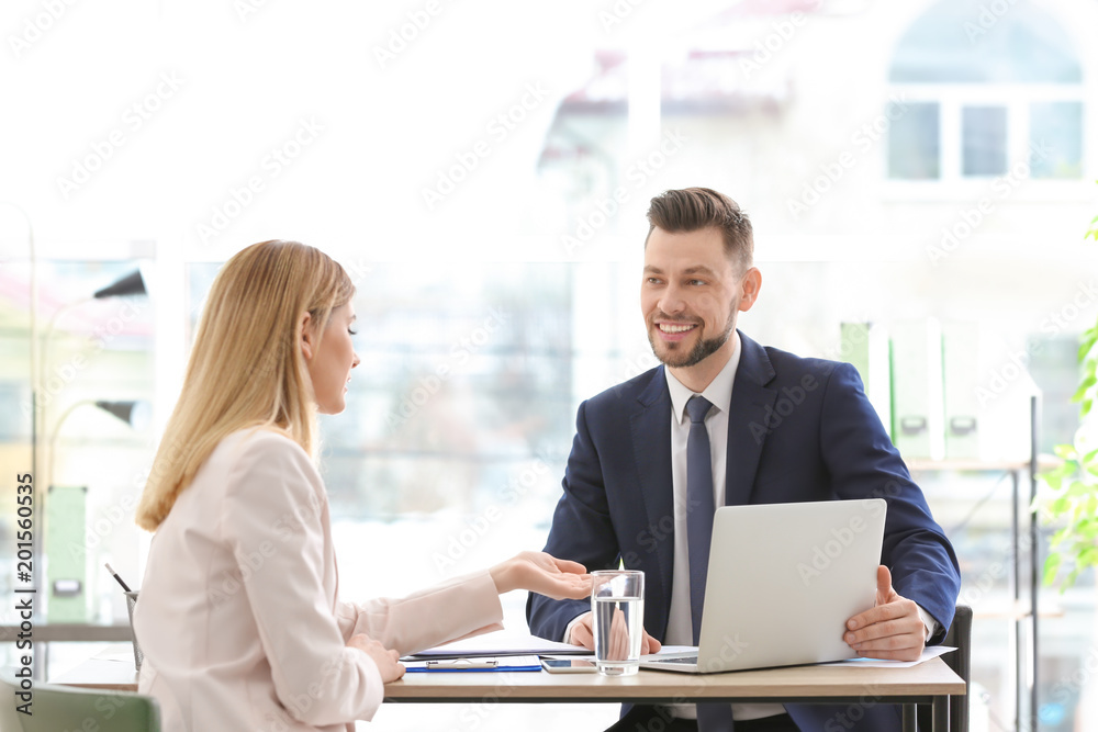 Young consultant working with client in office Young consultant working with client in office