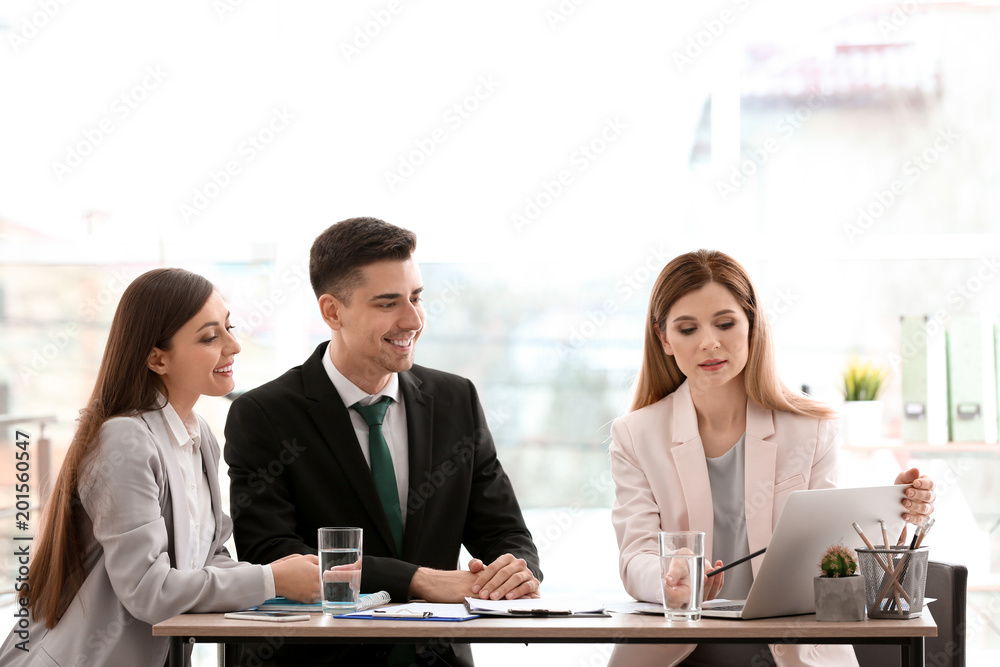 Young consultant working with clients in office Young consultant working with clients in office